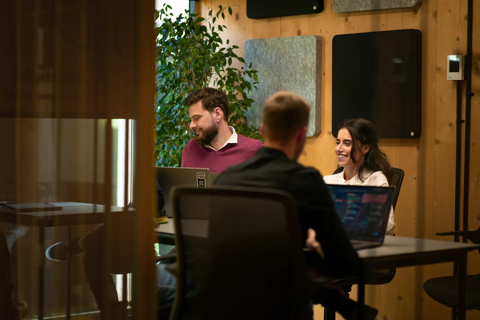An agency team working together at laptops in a meeting room